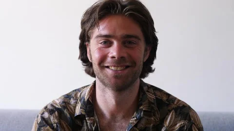 Handsome young man smiling at the camera communicating positivity Stock Footage 289002702