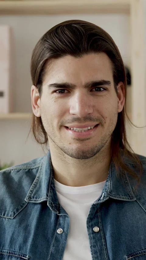 Handsome young man smiling at the camera Stock-Footage 345386180