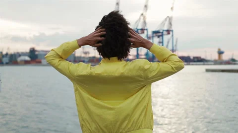Handsome young man standing alone on the deck of a ship Stock Footage 38338786