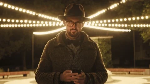 Handsome young man, is super connected to friends and family chats and texts on Stock Footage 156791157