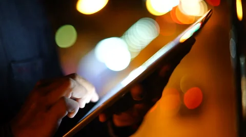Handsome, young man with tablet computer in city at night Stock Footage 63540858