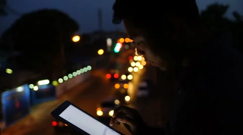 Handsome, young man with tablet computer in city at night Stock Footage 63547305