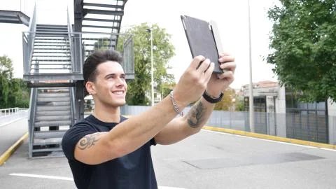 Handsome young man with tablet PC in city Stock Photos