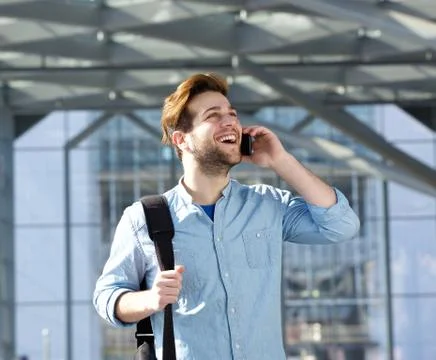 Handsome young man talking on cell phone Stock Photos