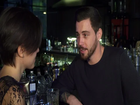 Handsome young man talking to his beautiful girlfriend at the bar Stock Footage 84687662