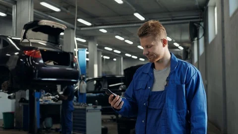 Handsome young man talking on the mobile phone and smiling while standing in Stock Footage 95260582