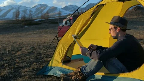 Handsome young man tourist using cell phone and portable mini speaker in Stock Footage 75790108