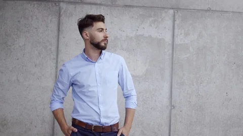 Handsome young man turning towards camera and laughing Stock Footage 112866978
