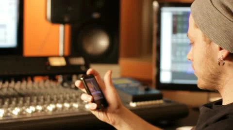 Handsome young man typing sms in recording studio Stock Footage 21743101