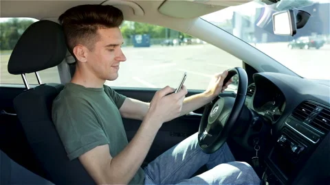 Handsome Young Man Using Cell Phone In A Driver Seat Of The Car. Stock Footage 123695826