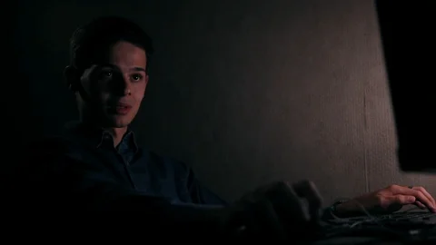 Handsome young man using computer in the room at night Video stock 99051135