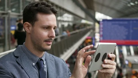 Handsome Young Man Using Digital Tablet Computer Screen Browsing the Internet Stock Footage 87738486