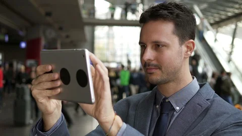 Handsome Young Man Using Digital Tablet Computer Screen Browsing the Internet Stock Footage 87739058