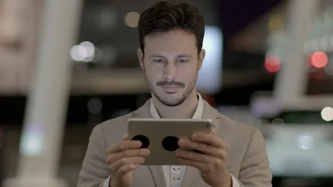 Handsome Young Man Using Digital Tablet Computer Screen Browsing the Internet 스톡 동영상 87745232