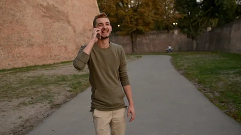 Handsome young man using his phone outdoors Stock Footage 88957999