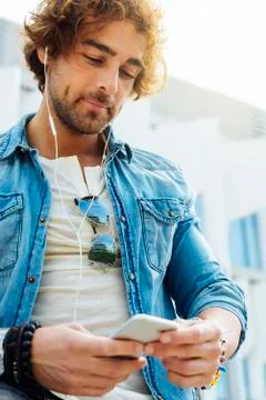Handsome young man using his mobile. Stock Photos