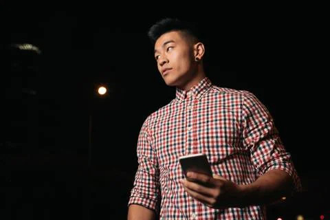 Handsome young man using his mobile. Stock Photos