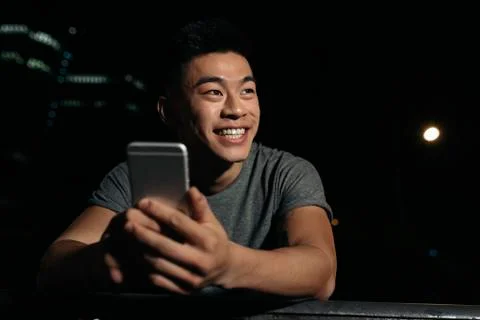 Handsome young man using his mobile. Stock Photos
