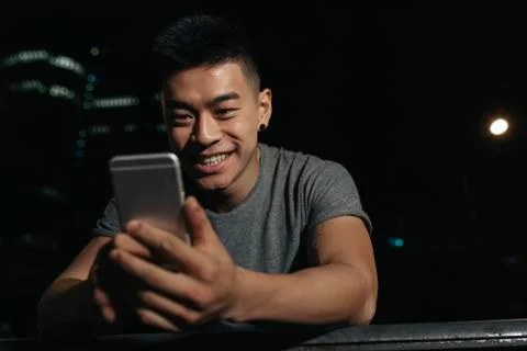 Handsome young man using his mobile. Stock Photos