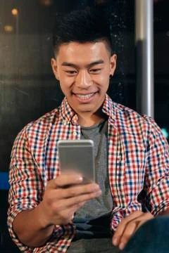 Handsome young man using his mobile. Stock Photos