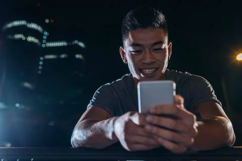 Handsome young man using his mobile. Stock Photos