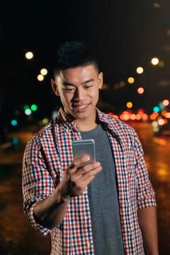 Handsome young man using his mobile. Stock Photos