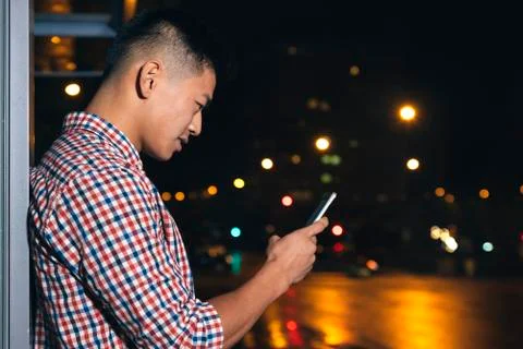Handsome young man using his mobile. Stock Photos