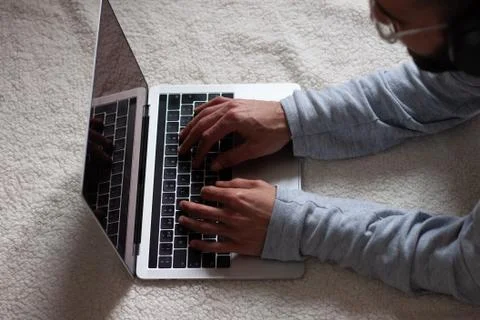 Handsome young man using his laptop while resting on the floor Foto stock