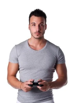 Handsome young man using joystick or joypad for videogames Stock Photos