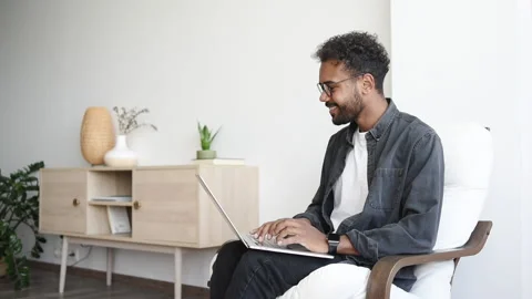 Handsome young man using laptop computer at home Stock Footage 163036516