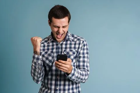 Handsome young man using mobile phone isolated Stock Photos