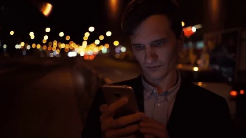 Handsome young man using smartphone smiling wearing casual suit jacket outdoors Stock Footage 80009552