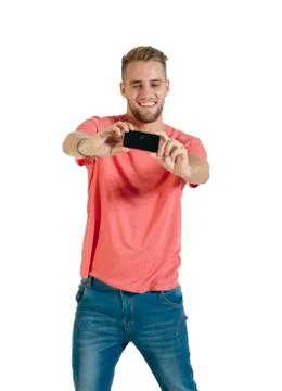 Handsome young man using a smartphone. Stock Photos