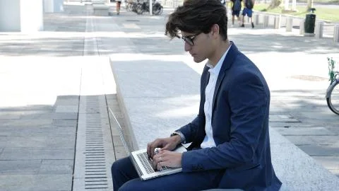 Handsome young man working at computer outdoor Stock Photos