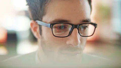 Handsome young man working in a touchscreen computer or tablet. Close up. Stock Footage