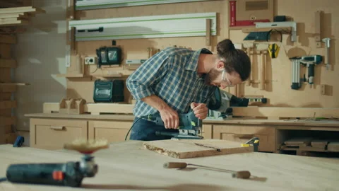 Handsome Young Men Carpenter Working with Jigsaw in Workshop. Woodworking. Video stock 220584761