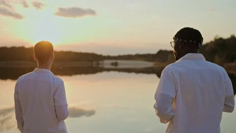 Handsome young men spend sunset at the beach, vaping and drinking Video stock 197171230