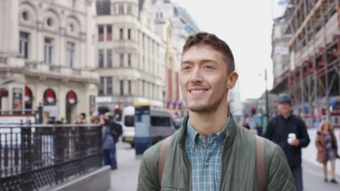 Handsome young mixed race man walking through the city, in slow motion Stock Footage 90363802