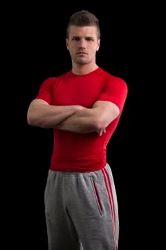 Handsome young personal trainer in studio Stock Photos