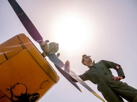 A handsome young pilot standing next to the propeller Stock Photos