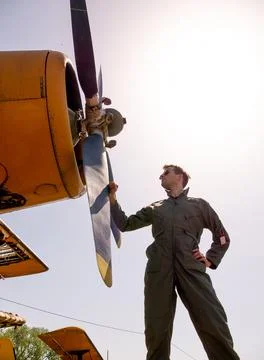 A handsome young pilot standing next to the propeller Stock Photos