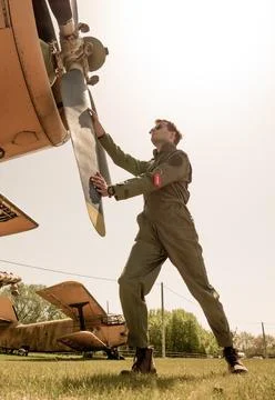 A handsome young pilot standing next to the propeller Stock Photos