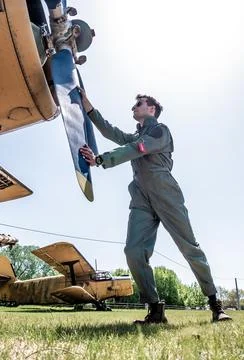 A handsome young pilot standing next to the propeller Stock Photos