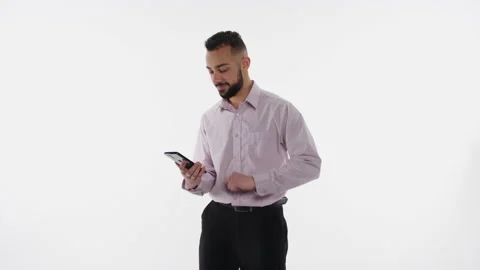 Handsome young professional swipes on smartphone and nods Video stock 153471353