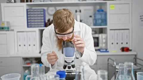 Handsome young redhead man, a professional scientist, harnessing the power .. Stock Footage 262695576
