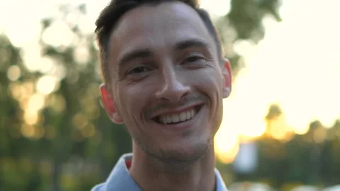Handsome young serious man portrait. Attractive guy looking at camera standing Stock Footage 123765874