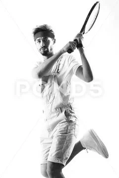 Handsome young sportsman holding racket isolated on white Stock Photos