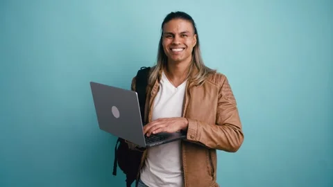 Handsome young student typing on a laptop computer Stock Footage 333073667
