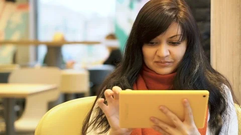 Handsome young woman using tablet  in a cafe. Stock Footage 83762816