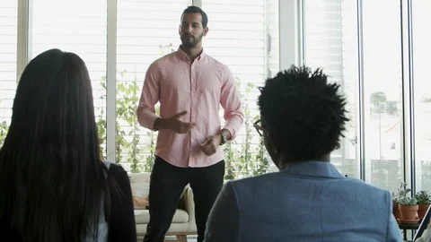 Handsome young worker speaking to colleagues Stock Footage 119979280